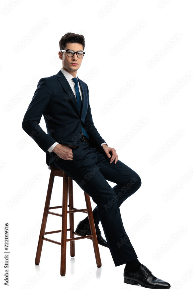 side view of confident elegant man with glasses holding hand in pocket side view of confident elegant man with glasses holding hand in pocket