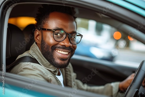 A content man behind the wheel, his reflection in the car mirror adorned with glasses and a smile, embodies the joy of a carefree drive in the great outdoors
