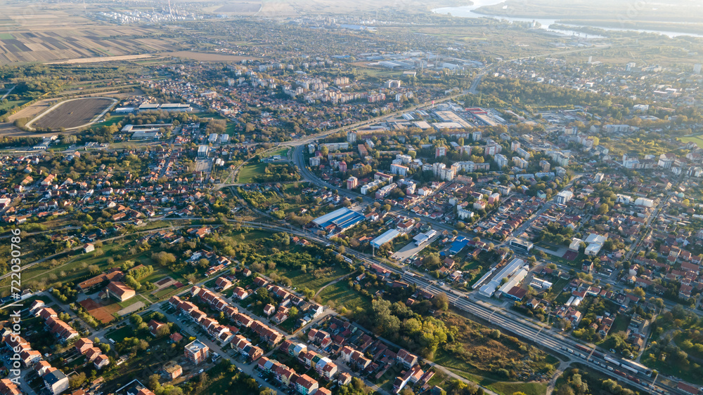 Fototapeta premium Aerial view of suburban houses in new modern development area. Small city on aerial view. Scenic seasonal landscape from above aerial view of a small town in countryside Pancevo, Serbia