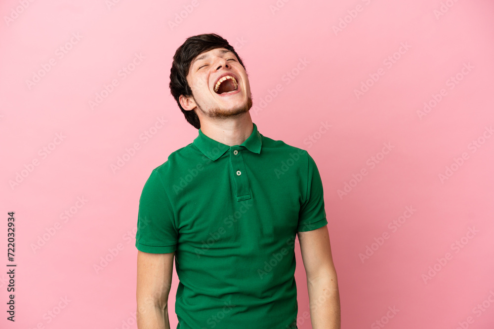 Young Russian man isolated on pink background laughing Young Russian man isolated on pink background laughing