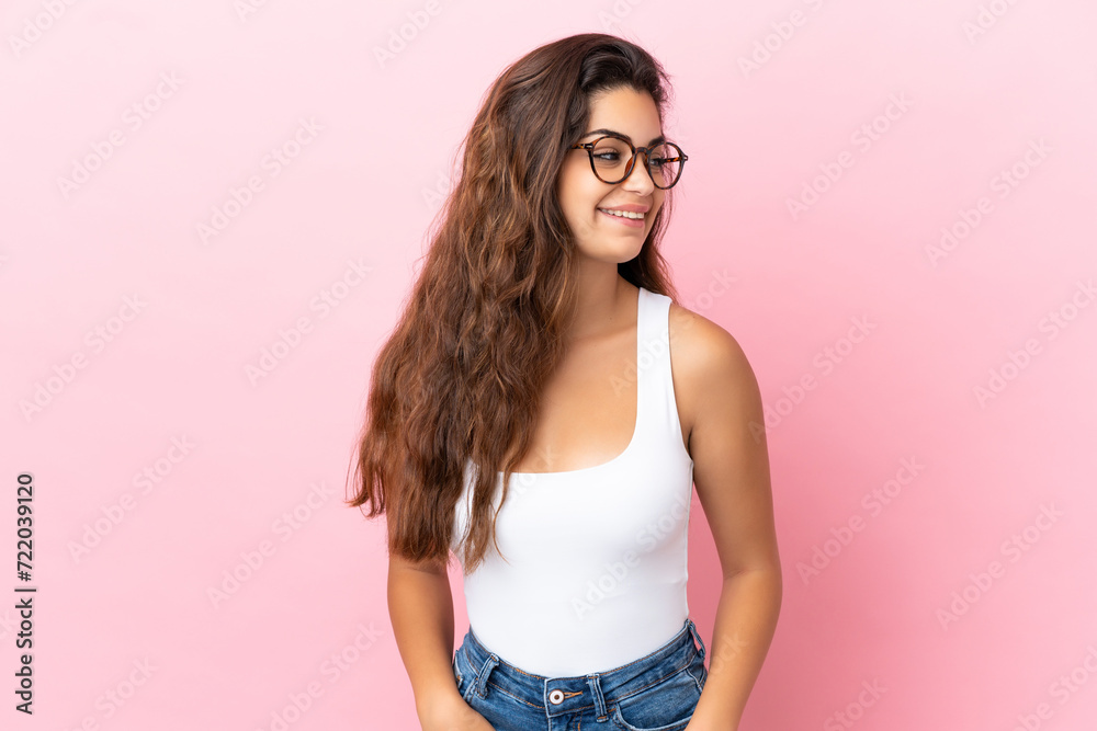 Young caucasian woman isolated on pink background looking side Young caucasian woman isolated on pink background looking side