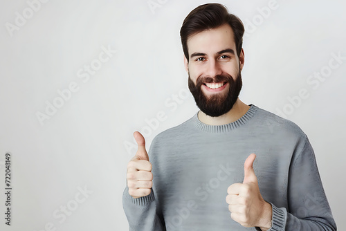 portrait of cheerful young man doing thumbs up on isolated background