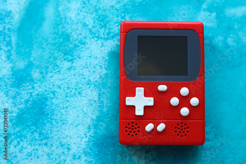 Retro video game console on a blue background, top view.