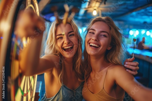 Two joyful women capture their lively dance and fashionable outfits in a selfie, radiating happiness and friendship