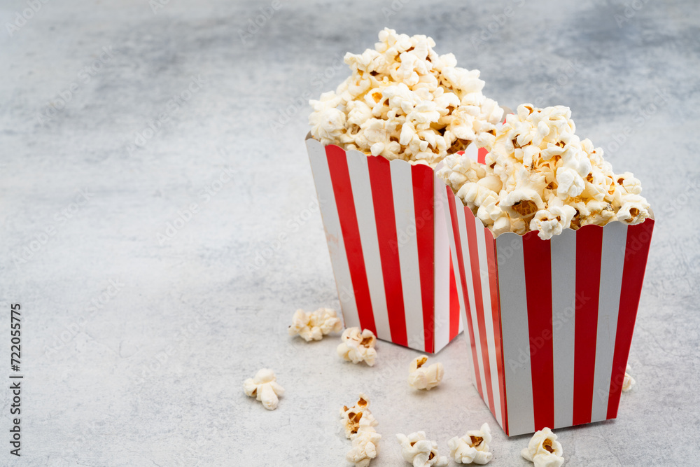 Popcorn in red and white striped paper box isolated on white background Popcorn in red and white striped paper box isolated on white background
