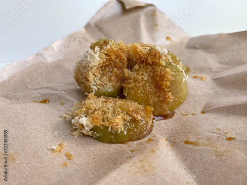 Lopis, traditional snack from indonesia, made from glutinous rice cake, sliced and served with grated coconut and liquid brown sugar photo