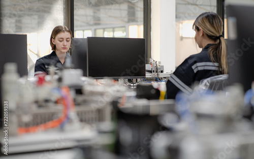 Engineer woman working on artificial intelligence in robotic and electronic engineering laboratory. University students' research project is programming robot machine with innovation software control