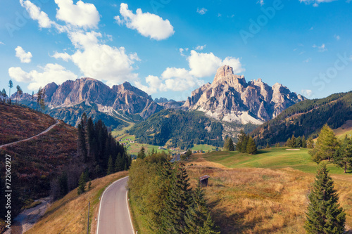 Mountain landscape background. Rocks against the background of the daytime sky. Dolomites in South Tyrol. Plank Road towards Corvara in Badia, Bolzano, Italy