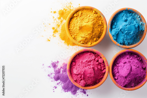 Vibrant indian holi festival color powders in four bowls on white background. Concept of colorful gulal, celebration, and cultural. photo