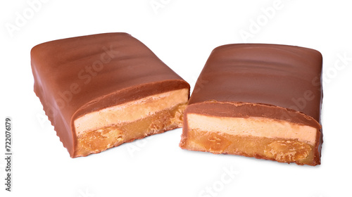 Pieces of tasty chocolate bars with nougat and nuts on white background