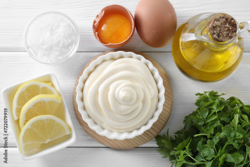 Fresh mayonnaise sauce in bowl and ingredients on white wooden table, flat lay Fresh mayonnaise sauce in bowl and ingredients on white wooden table, flat lay
