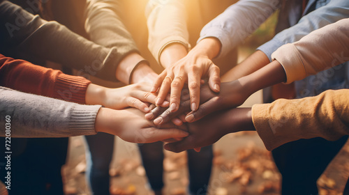 Unified Strength: Group of People Stacking Hands Together in Solidarity photo