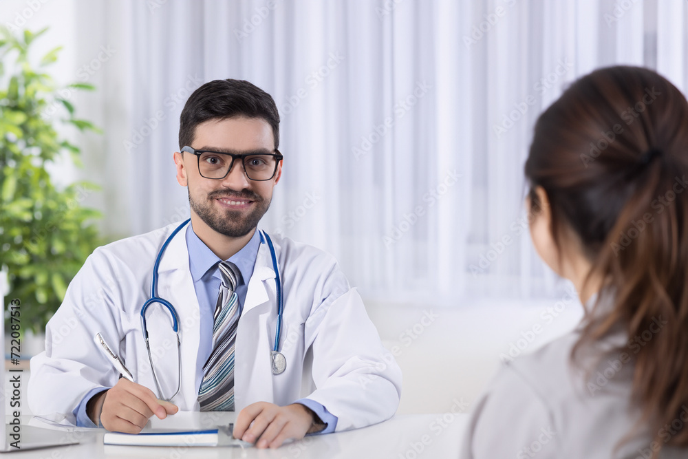 Doctor talking and laughing with his patient Doctor talking and laughing with his patient