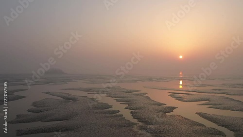 Beach scenery with mudflats overlooking the sunrise
 photo