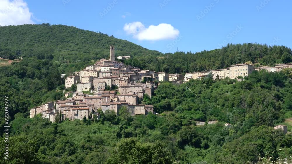 The beautiful village of Castelnuovo Val di Cecina on a sunny summer morning. Province of Pisa, Tuscany, Italy. The beautiful village of Castelnuovo Val di Cecina on a sunny summer morning. Province of Pisa, Tuscany, Italy.