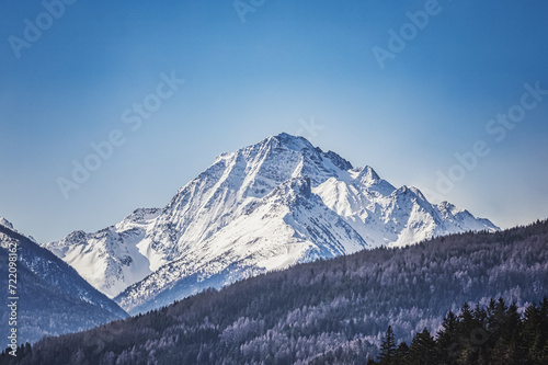 Snow-capped mountains at sunrise, a breathtaking alpine landscape, Tyrol, Austria © Wirestock