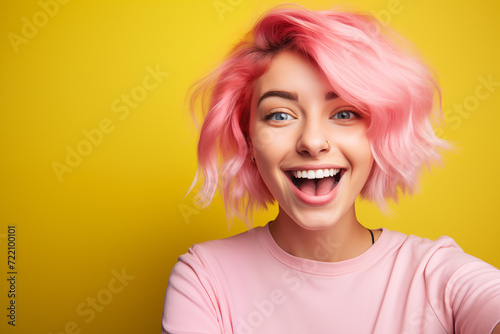 Young pink haired woman over isolated colorful background making a selfie
