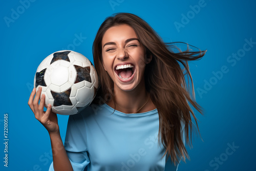 Young pretty brunette girl over isolated colorful background holding soccer ball