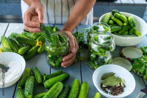 Preserving cucumbers in jars. Selective focus.