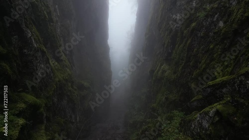 Drone flying inside a gorge on a misty day photo
