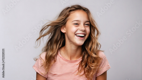 Studio portrait of cheerful young girl laughing and cheerful. On a colored background.. Copyscape.