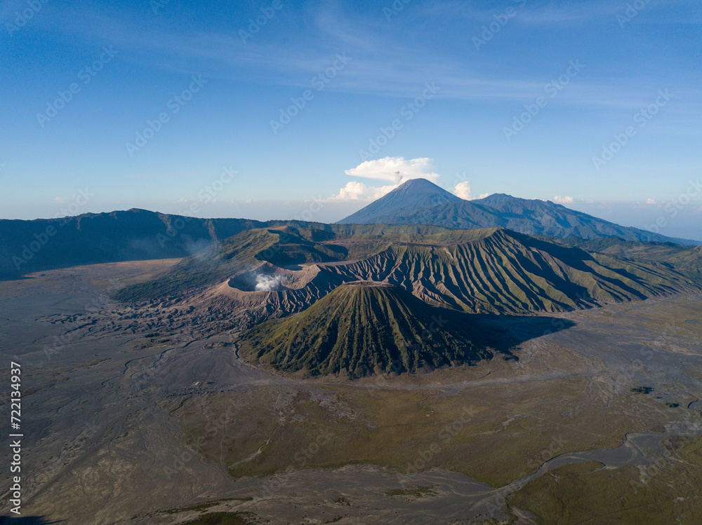 Aerial view of a majestic volcanic landscape with a smoking crater