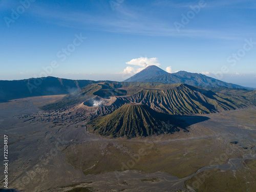 Aerial view of a majestic volcanic landscape with a smoking crater