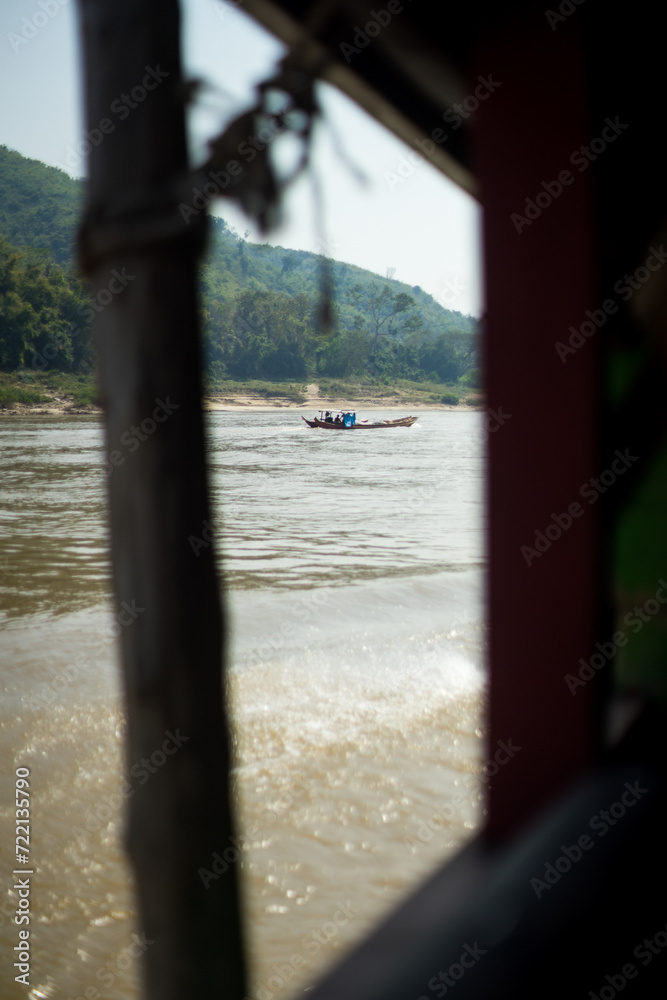 A view from a boat to another vessel navigating a river