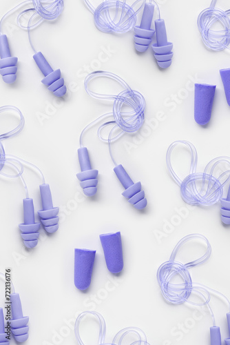 Different earplugs as minimal style pattern  comfort silicone and rubber ear plug on string protection against noise  protect hear  for swim  sleep  rest. Top view flat lay photo pattern