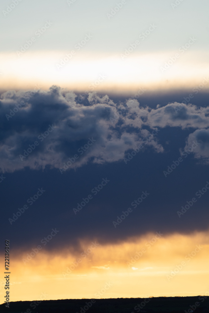 Fototapeta premium Beautiful blue and orange sky with clouds at twilight