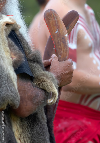 Human hand holds ritual clapsticks for the welcome ritual rite at an indigenous community event in Australia photo