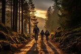 A group of cyclists rides along a forest path in the sun. Spring weather for cycling. Sports activities in nature. Recreational type of holiday
