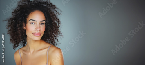 Model girl with shiny smooth healthy hair with curly hair and glowing, tan skin natural beauty smooth skin for Care, and hair and skin care products