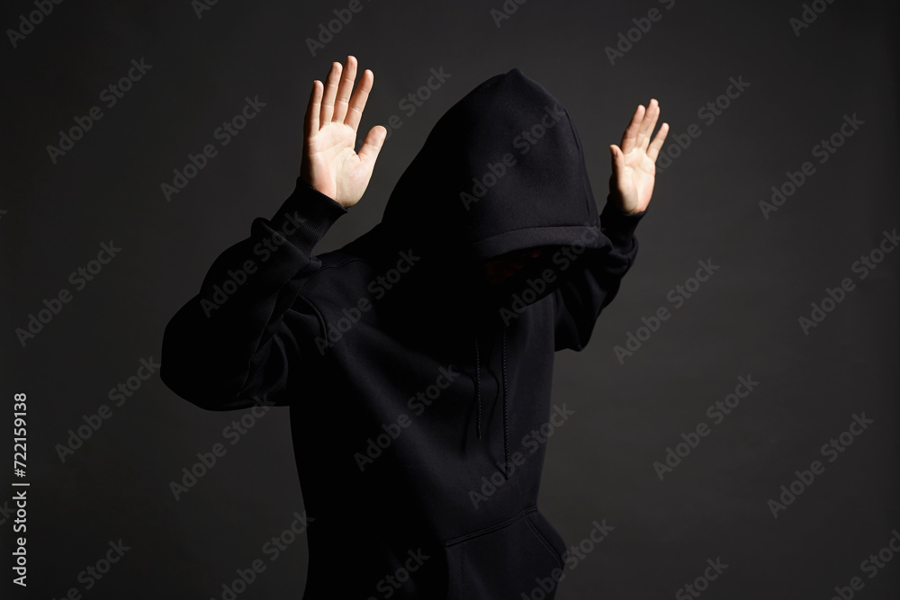 Boy in Black Hood raising his hands up to be arrested Boy in Black Hood raising his hands up to be arrested