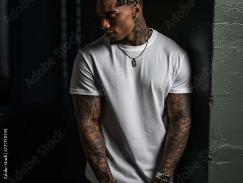 Mockup of a black man with tattoos wearing a white T-shirt