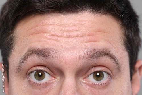 Closeup view of man with wrinkles on his forehead photo