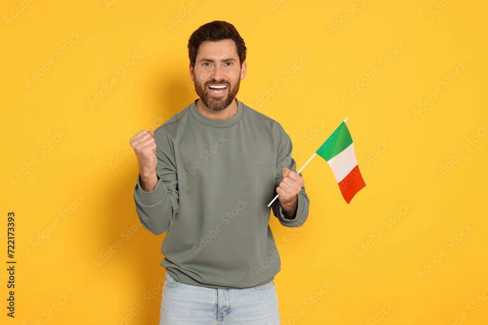 Man with flag of Italy on yellow background Man with flag of Italy on yellow background