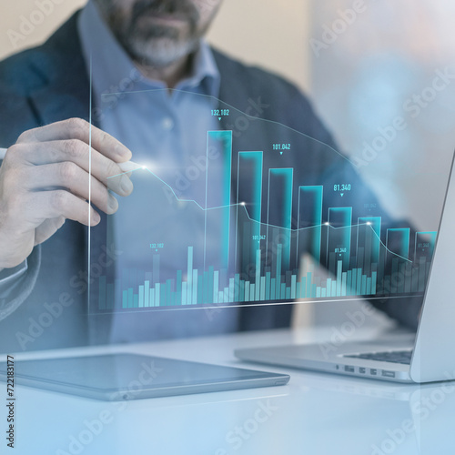 Businessman calculating ROI with laptop. Return of investment, increase of value, dividend concept.