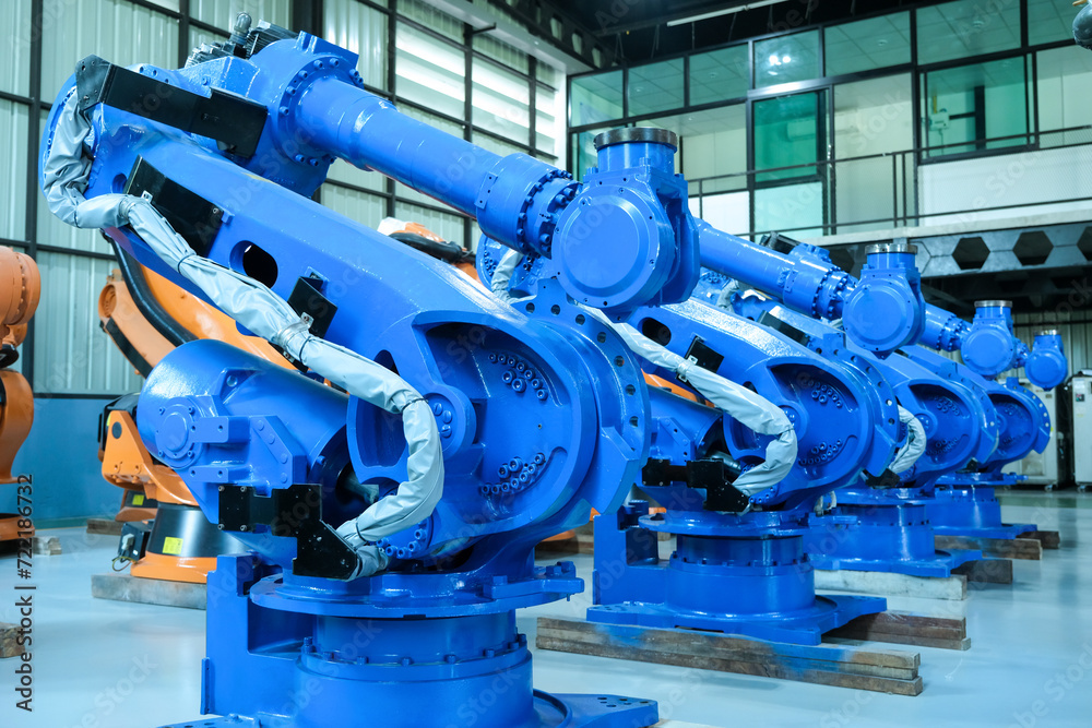 Blue robot arms assemble for automotive industry.Automated production line with robotic arms in factory. Blue robot arms assemble for automotive industry.Automated production line with robotic arms in factory.