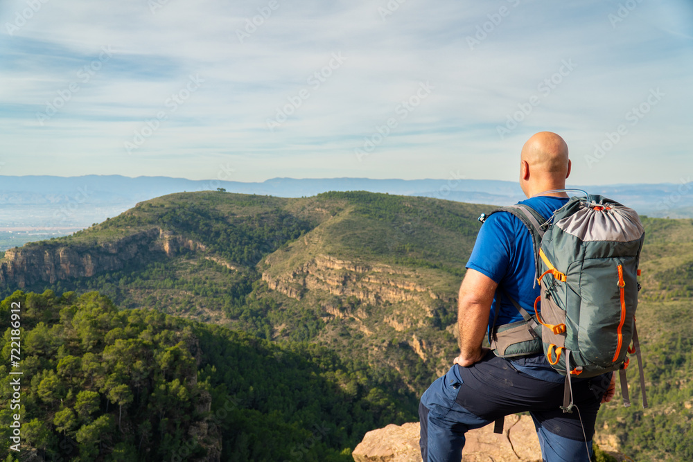Back view of a male hiker looking at the landscape Back view of a male hiker looking at the landscape