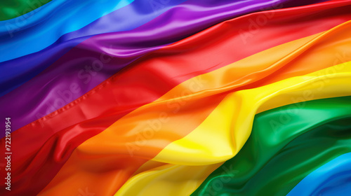 Vibrant and colorful close up image of the rainbow flag, a symbol of LGBTQ+ pride and diversity, made of smooth, silky fabric with a flowing, wavy texture. Unity in diversity