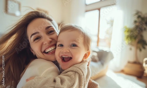 Joyful Mother Holding Happy Baby smile at home