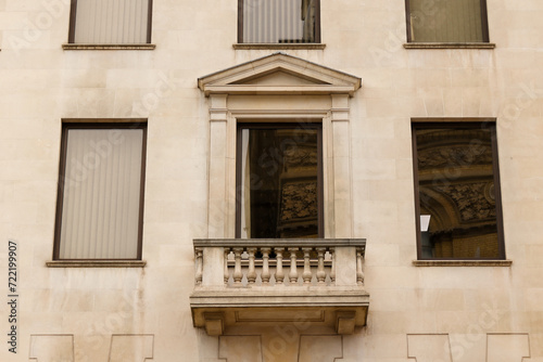 Facade of a London building with a marble stone balcony. ​London, Great Britain 08.14.2023