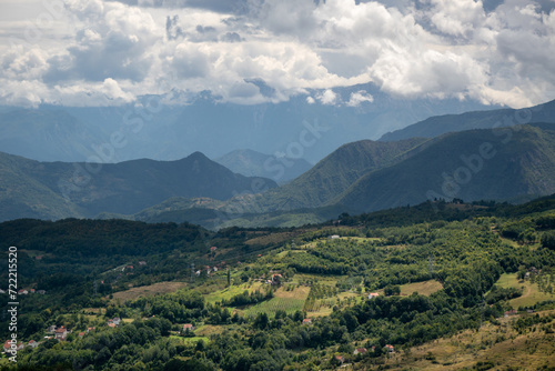 Mountain village against mountains in haze, countryside near Prozor in Bosnia and Herzegovina, mountain landscape