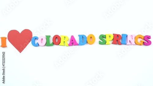 I love Colorado Springs. Text from colorful wooden letters and a beating paper red heart.