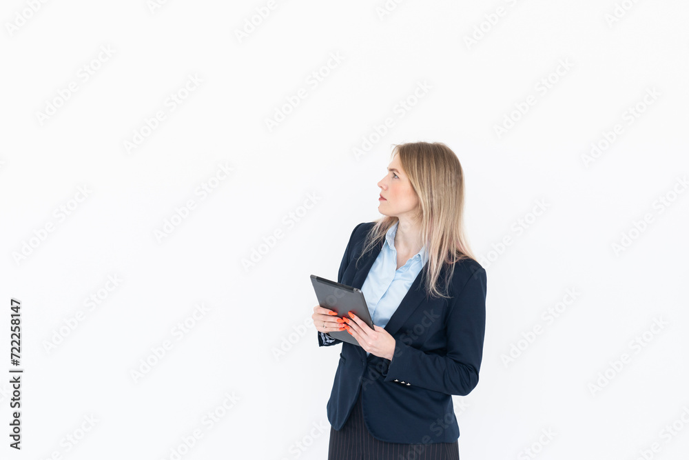Young attractive business woman in black suit holding gadget isolated on white. Copy space and place for text concept Young attractive business woman in black suit holding gadget isolated on white. Copy space and place for text concept