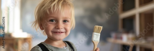 Little Boy Holding a Paintbrush in His Hand