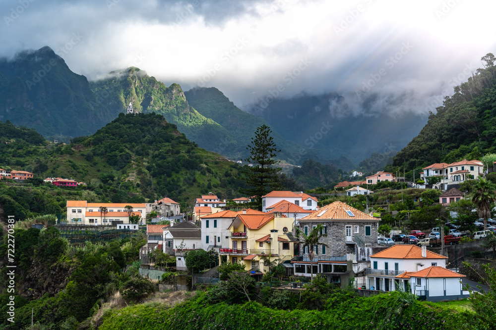 Picturesque town on the north coast in a green, overgrown valley on a cloudy day. Sao Vincente, Madeira Island, Portugal, Europe.