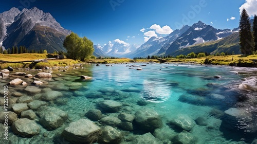 Amazing alpine lake landscape with crystal clear green water and perfect blue sky. Panoramic view of beautiful mountain landscape in the Alps with lake