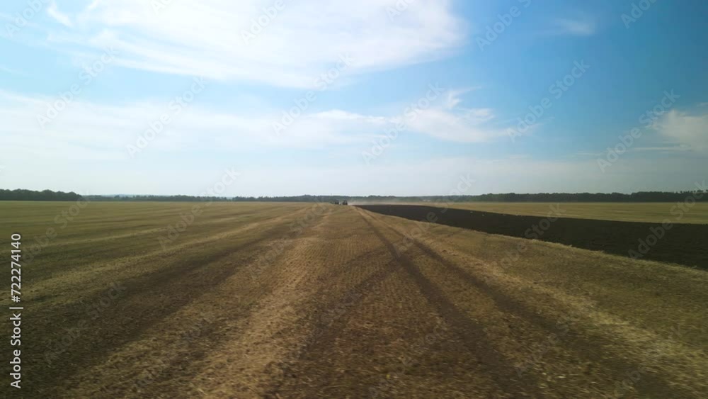 Tractors plowing the field in Ukraine Tractors plowing the field in Ukraine
